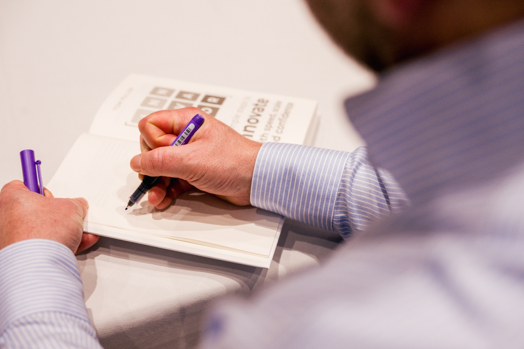 Tom Pullen signing a copy of INNOVATOR